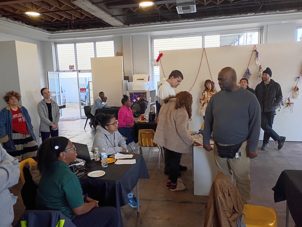 Gathering of people inside our gallery, at the reception for Face to Face. People include artist Louis, Farring-Baybrook artists, and other friends. 